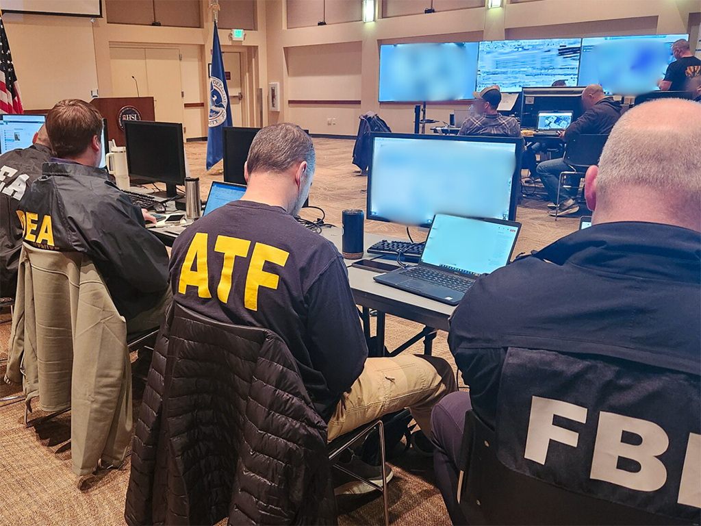 Federal law enforcement officials from U.S. Immigration and Customs Enforcement, the Drug Enforcement Administration, the ATF and the FBI run an enhanced immigration enforcement operation from the Operations Command Center in Denver Feb. 5.