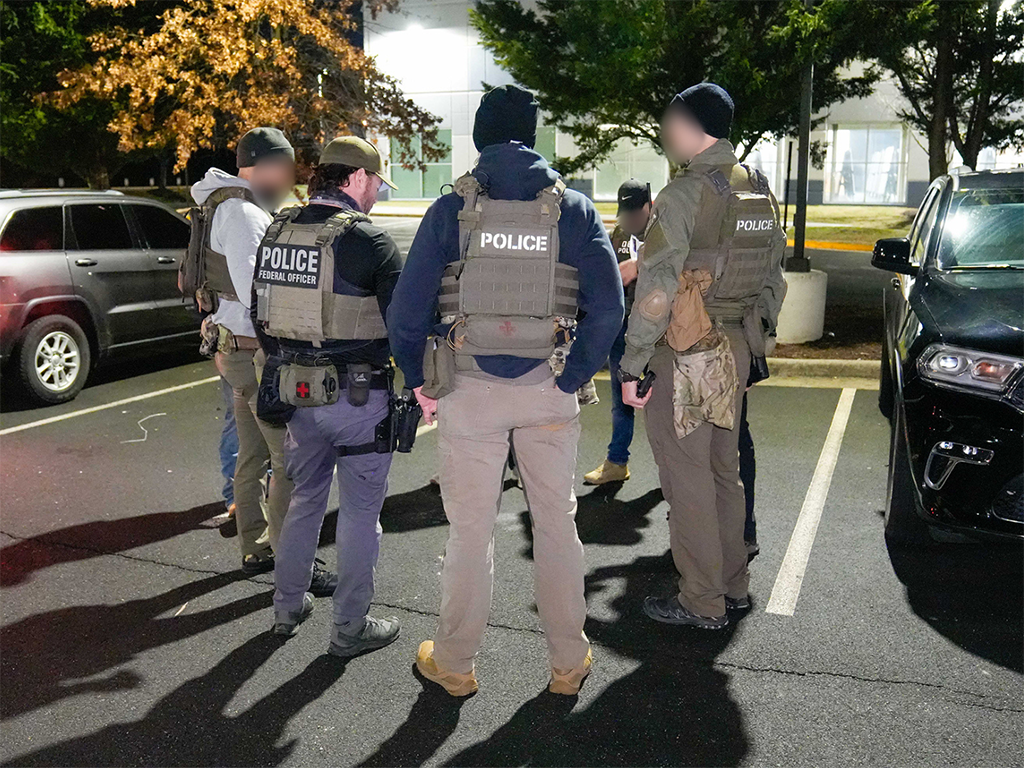 Federal law enforcement officials conduct a pre-operational briefing in a Washington, D.C.-area parking lot Feb. 4. This enhanced immigration enforcement operation involved cooperation between U.S. Immigration and Customs Enforcement and its federal law enforcement partners with the Drug Enforcement Administration.