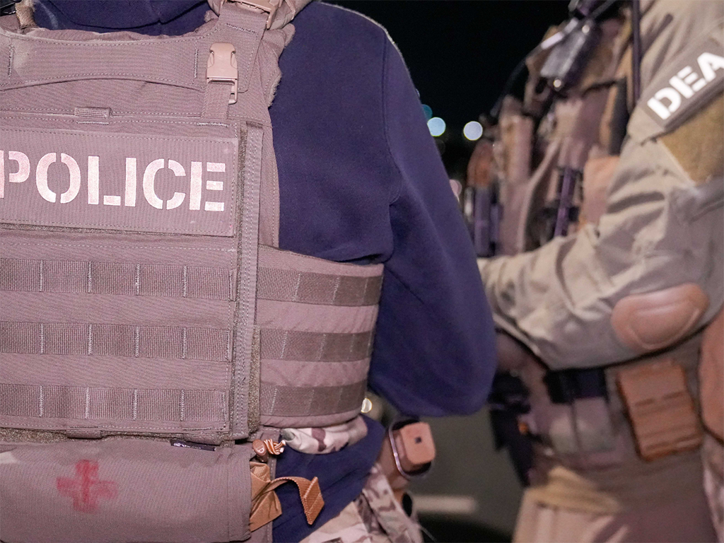 ICE and DEA law enforcement officials conduct a pre-dawn briefing prior to an enhanced immigration enforcement operation in a Washington, D.C. suburb on the morning of Feb. 4.