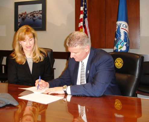 Kathleen Guinee, owner of Aetna Fire Alarm Service Company, Inc., signs an IMAGE agreement.