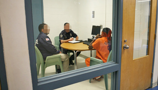 2 ICE Agents in a room with a detainee