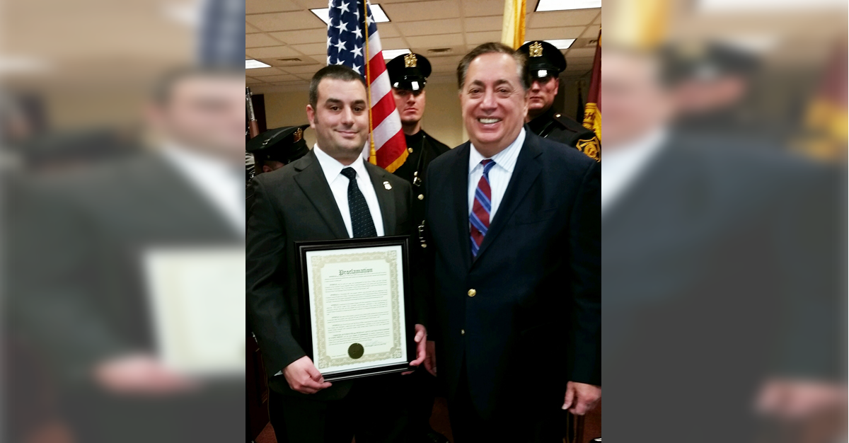 ICE Deportation Officer John Belluardo (left) receives an award from North Bergen Mayor Nicholas Sacco for his work in locating a hit-and-run driver in Maryland.