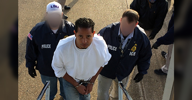 Marlon Joel Paz-Mendoza boards a plane for return to Honduras, where he has been convicted of murder.
