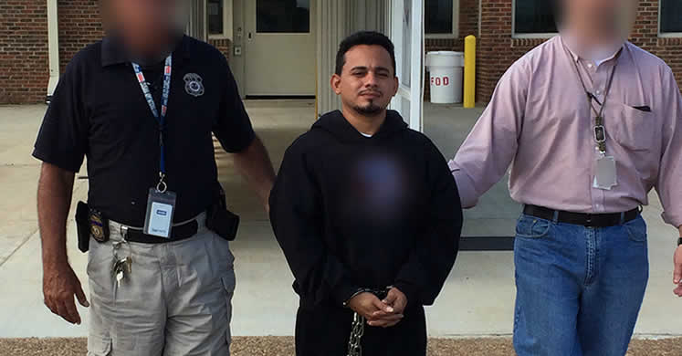 ERO officers escort Jose David Alvarenga-Ramos, who is wanted for aggravated murder in El Salvador, to an ICE Air charter plane for removal from the U.S.