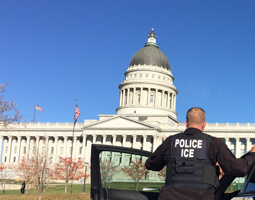 SLC Deportation Officer standing before Utah State Capitol.